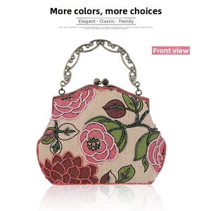 Detail of floral beadwork embroidery on linen evening bag with vintage bronze clasp