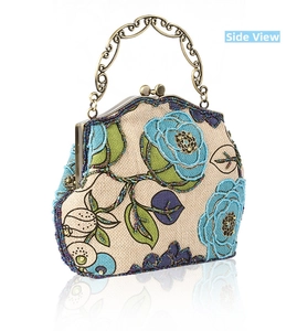 Detail view of handmade beaded floral embroidery on vintage linen handbag with metal handle