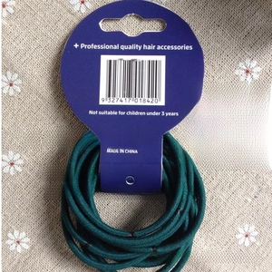 Detail of 3mm dark green elastic hair ties on a professional quality cardboard display
