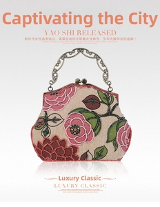 Detailed view of the vintage beaded floral embroidery and ornate bronze metal handle
