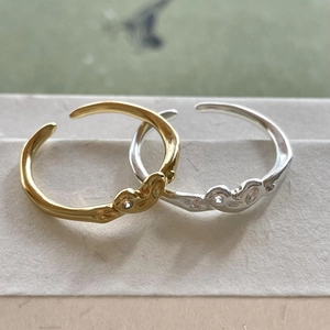 Set of gold and silver wave-shaped 925 sterling silver open rings with polished finish