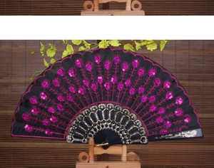 Close-up of rose red floral embroidery and sequins on a black folding dance fan