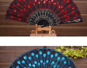 Close-up of Chinese folding fans with sequins, lace edges and golden frame patterns
