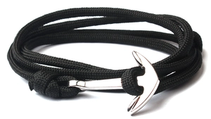 Close-up of black braided nylon cord bracelet with silver anchor clasp on white background