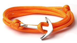 Close-up of orange braided nylon rope and silver nautical anchor clasp of the bracelet