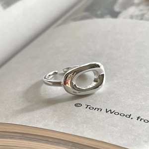Detailed view of an irregular oval 925 sterling silver ring on a book page