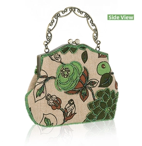 Detail of vintage beaded embroidery on linen bag with bronze floral handle