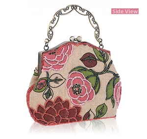 Detailed side view of vintage linen bag featuring floral bead embroidery and ornate metal handle
