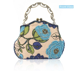 Close-up of vintage bronze hollow-carved handle and floral beadwork on linen handbag