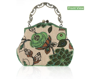 Detail of vintage linen handbag with floral bead embroidery and carved metal handle