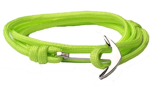 Detail of neon green woven cord bracelet with silver anchor-shaped metal clasp