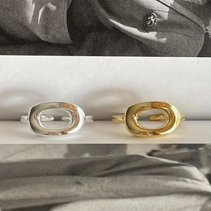 Macro shot of minimalist oval hollow open rings in polished silver and gold finishes