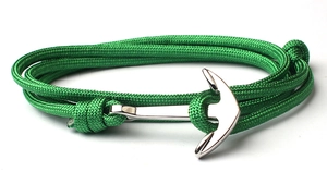 Detail of green nylon braided bracelet featuring a silver anchor metal clasp closure