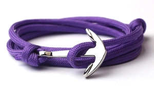 Detail of nautical purple braided bracelet with a polished silver anchor metal clasp