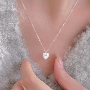 Minimalist 925 sterling silver heart necklace with vintage texture on knitted sweater
