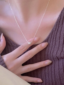 Detail of S925 sterling silver minimalist geometric necklace on a person's neck