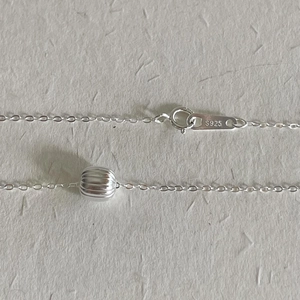 Close-up of S925 sterling silver necklace showing O-chain and watermelon bead pendant