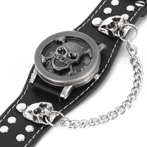 Detail of black leather punk watch featuring silver skull motifs and metal chains