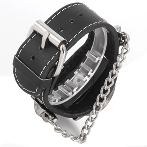Detail of punk leather bracelet featuring metal skull charms and silver link chain