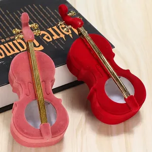 Elegant violin-shaped velvet jewelry box in red and pink with gold metal accents