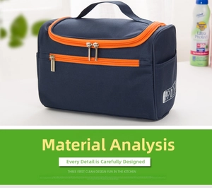 Detail of blue oxford travel toiletry bag with vibrant orange zippers and side handle