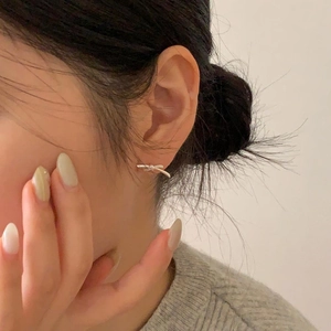 Detailed close-up of a minimalist 925 silver knot stud earring worn by a model