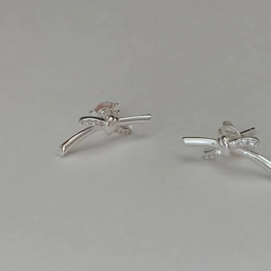 Elegant S925 sterling silver bow knot stud earrings with shimmering zircon crystals