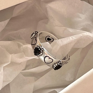 Detail of 925 sterling silver heart ring with black enamel in a gift box packaging