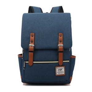 Blue canvas outdoor travel backpack with brown leather straps and vintage flap design