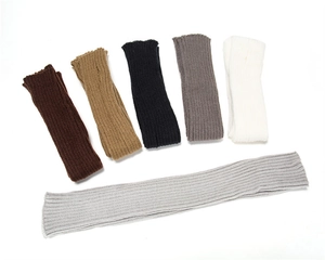 Detail view of 50cm long knitted arm warmers in various colors including grey and black