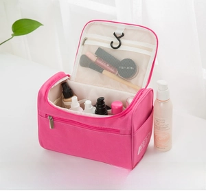 Detail of pink waterproof hanging toiletry bag showing internal mesh pockets and top hook