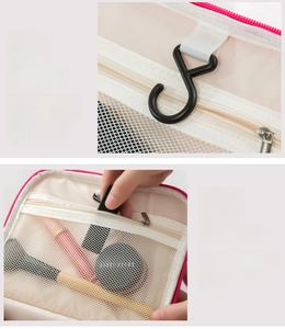 Detail of hanging S-hook and mesh storage compartments in travel toiletry bag