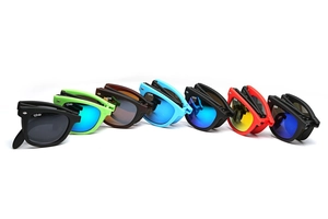 Detailed flat lay of colorful foldable sunglasses showing various frames in vibrant colors