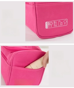 Detail view of reinforced edges and functional side pocket on the pink wash bag