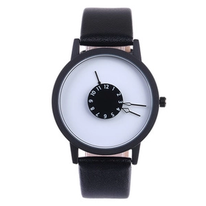Close-up of a minimalist quartz watch with a unique rotating white numeric dial disk