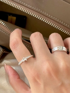 Detail of S925 sterling silver rings with star texture and minimalist pearl design