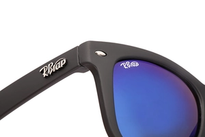 Macro shot of matte black sunglasses frame with blue lens and precision metal hinge