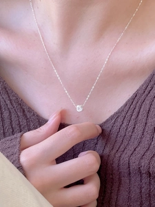 Detailed close-up of a minimalist 925 sterling silver square pendant on a delicate chain