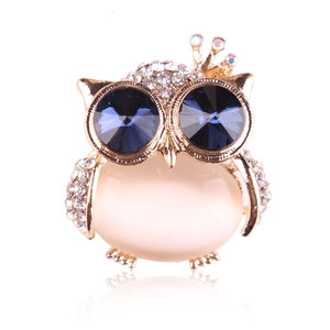 Elegant owl brooch with cat eye stone and sparkling blue crystal eyes on gold base