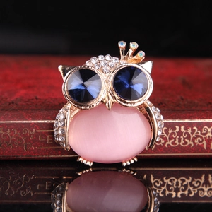 Elegant owl brooch with pink opal, blue crystal eyes, and silver-tone crown detail