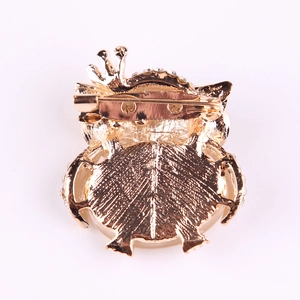Golden crown owl brooch with opal eyes featuring a secure back safety pin clasp
