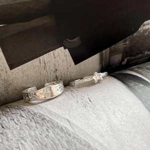 Detail of S925 sterling silver rings set featuring star engraving and minimalist band