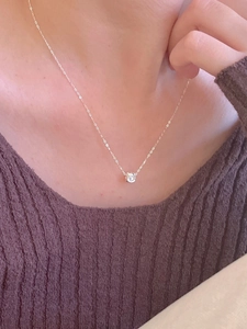 Minimalist 925 sterling silver cylinder pendant necklace shown on a model neck