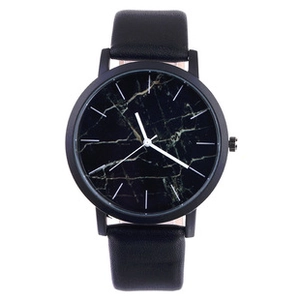 Close-up of minimalist black watch with luxury marble texture dial and leather strap