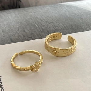 Close-up of S925 sterling silver stamp and handmade hammered texture on gold rings