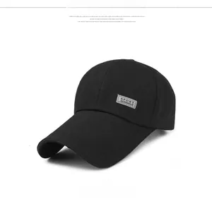 Detail view of a black canvas baseball cap with a sport rectangular patch on the side