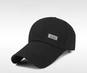 Detail of black cotton baseball cap showing side sport patch and curved sun visor brim