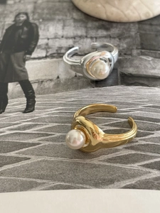Detail of adjustable gold and silver open rings with 8mm round white pearls