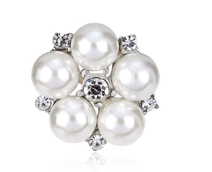 Detailed macro view of a silver floral brooch featuring white pearls and clear crystals