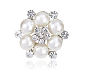 Close-up of elegant flower brooch with white imitation pearls and sparkling crystals